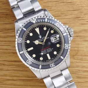 https://nolatimemachines.com/wp-content/uploads/2025/08/Rolex_1680_Red_Sub__Folded-Link_AS00996_Culture1-300x300.webp